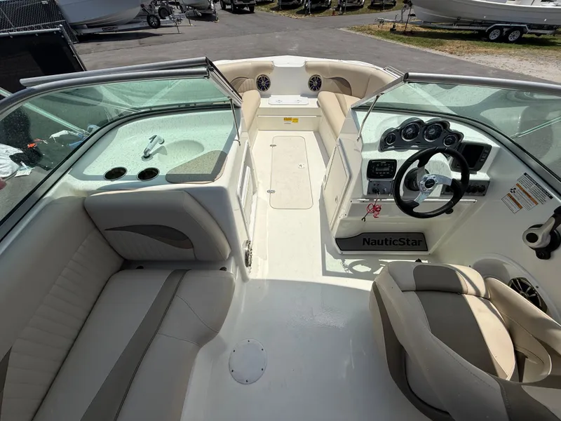 Slide: The Image of 2014 NauticStar 203DC Sport Deck boat interior with seating and steering console. - 14