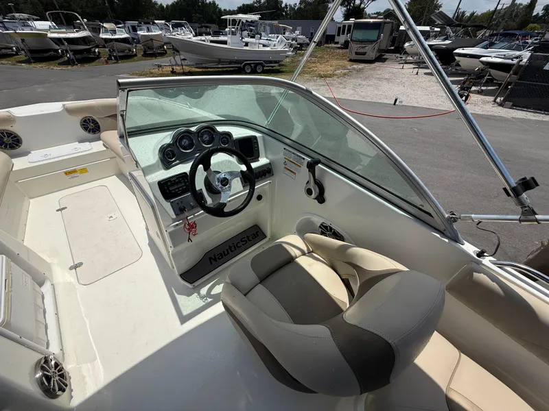 Slide: The Image of 2014 NauticStar 203DC Sport Deck boat interior with steering wheel and seating. - 15