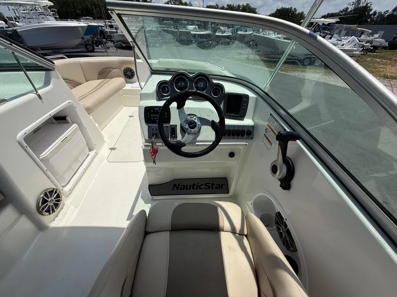 Slide: The Image of 2014 NauticStar 203DC Sport Deck boat interior with steering wheel and seating. - 16