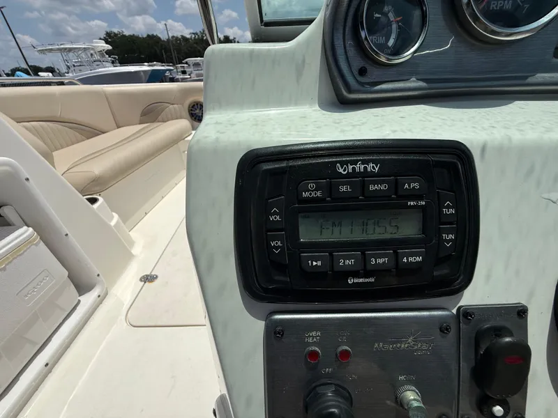 Slide: The Image of 2014 NauticStar 203DC Sport Deck dashboard with Infinity stereo system. - 19