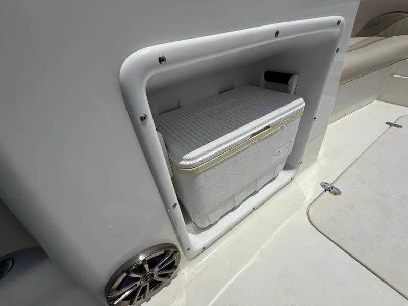 Slide: The Image of 2014 NauticStar 203DC Sport Deck boat with built-in cooler storage compartment. - 24