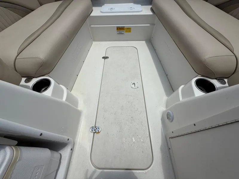 Slide: The Image of 2014 NauticStar 203DC Sport Deck interior with beige seating and cup holders. - 25