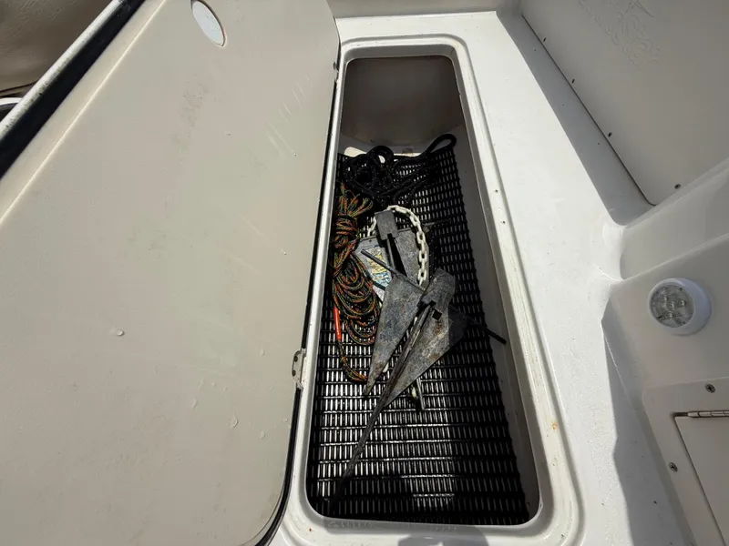 Slide: The Image of Storage compartment with anchor and ropes on 2014 NauticStar 203DC Sport Deck boat. - 26
