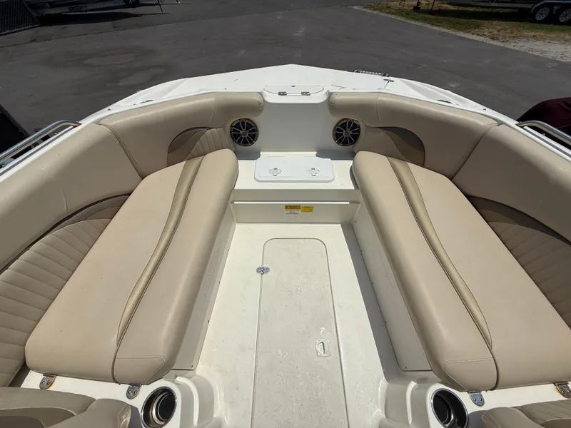 Slide: The Image of 2014 NauticStar 203DC Sport Deck boat interior with beige seating and cup holders. - 27