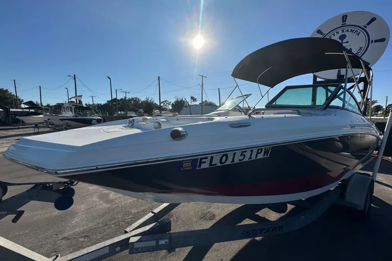 Slide: The Image of 2014 NauticStar 203DC Sport Deck boat on trailer under sunny sky. - 3