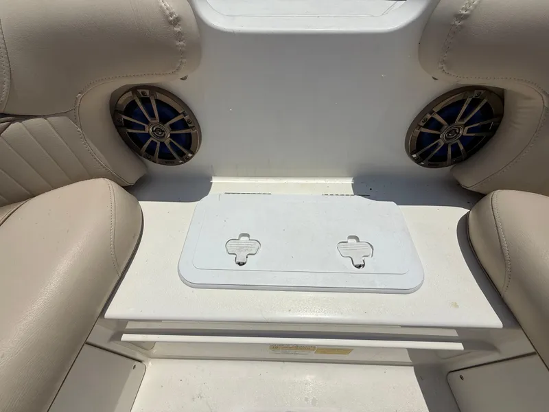 Slide: The Image of 2014 NauticStar 203DC Sport Deck interior with speakers and seating. - 32