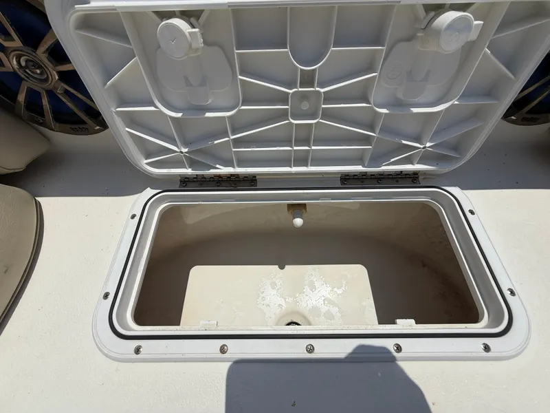 Slide: The Image of Open storage compartment on 2014 NauticStar 203DC Sport Deck boat. - 33