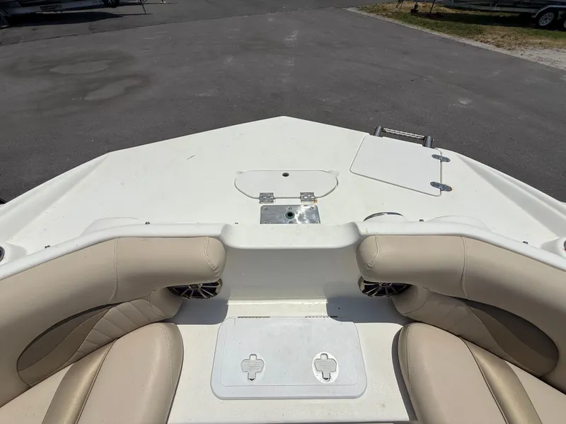 Slide: The Image of 2014 NauticStar 203DC Sport Deck boat interior with beige seating and storage compartments. - 34