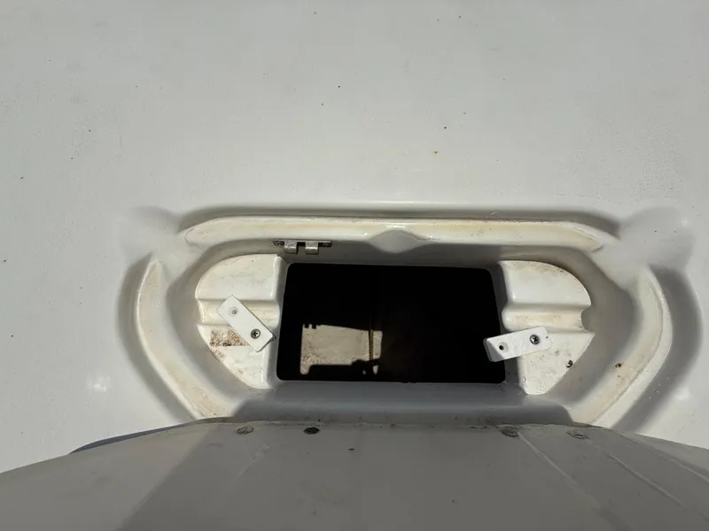 Slide: The Image of Open storage compartment on 2014 NauticStar 203DC Sport Deck boat. - 36