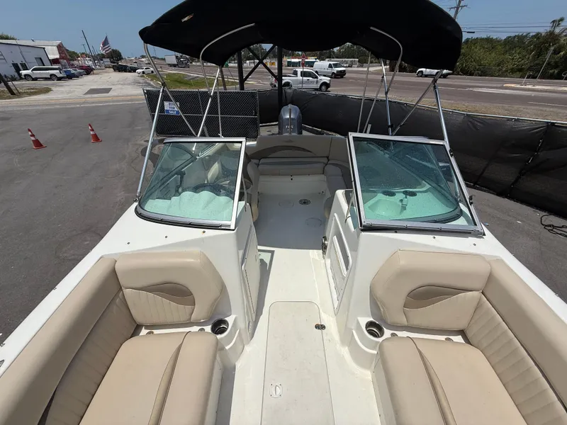 Slide: The Image of 2014 NauticStar 203DC Sport Deck boat with beige seating and black canopy. - 41