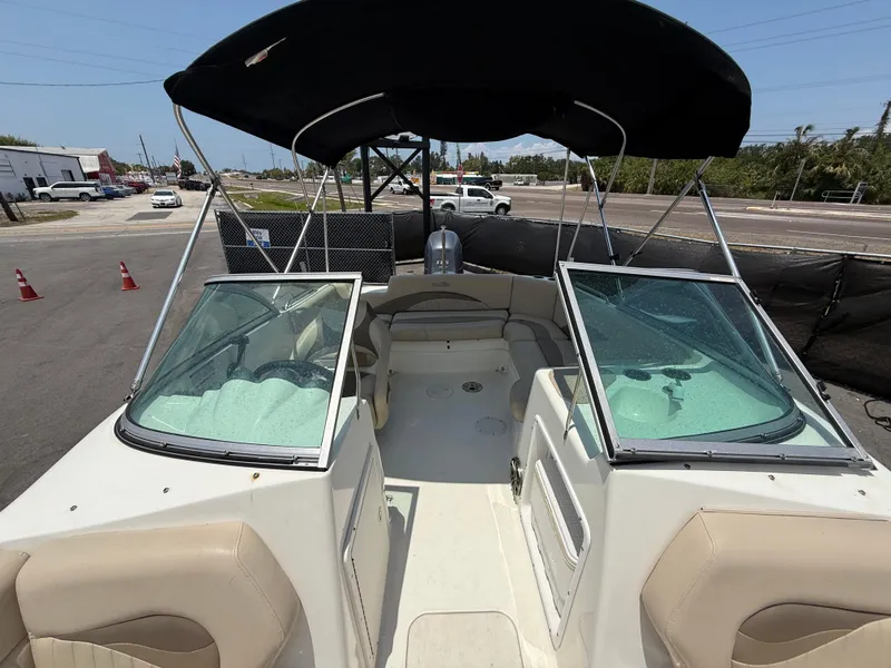 Slide: The Image of 2014 NauticStar 203DC Sport Deck boat with canopy, parked on a trailer. - 42