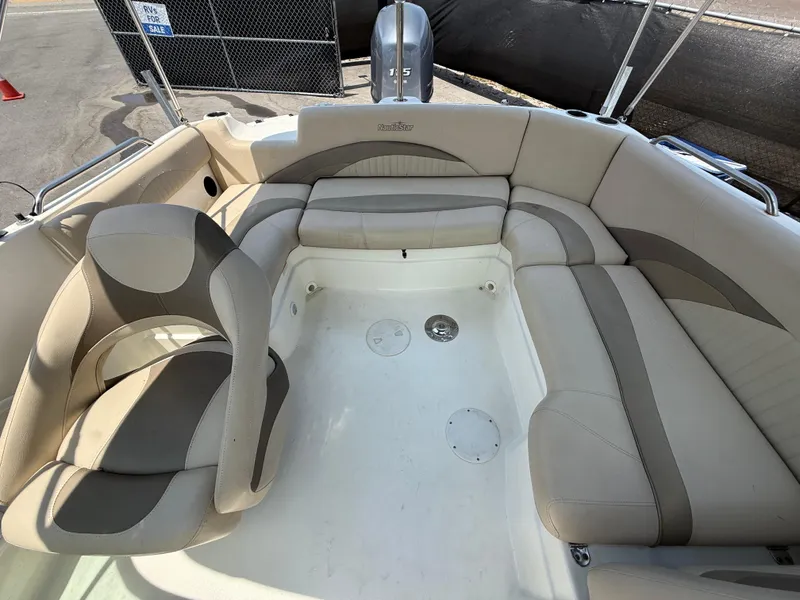 Slide: The Image of 2014 NauticStar 203DC Sport Deck boat interior with beige seating and spacious layout. - 45