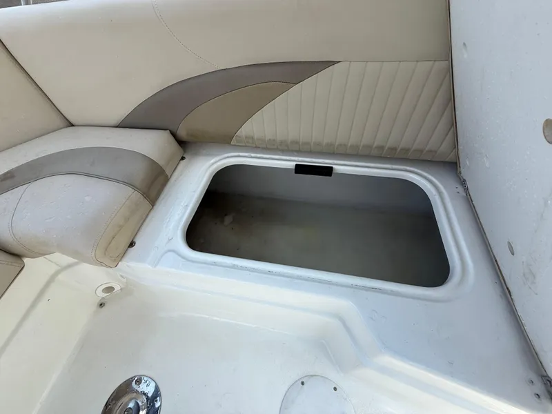 Slide: The Image of 2014 NauticStar 203DC Sport Deck boat storage compartment with beige seating. - 47