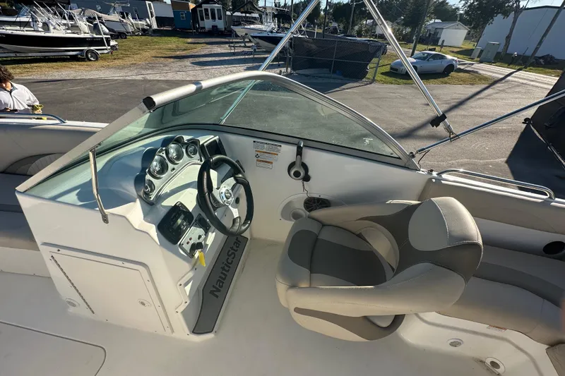 Slide: The Image of 2014 NauticStar 203DC Sport Deck boat interior with steering wheel and seating. - 49
