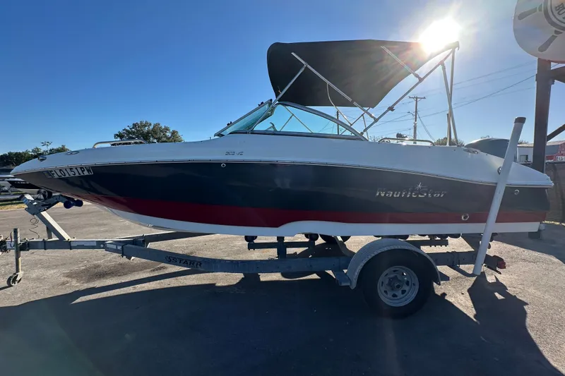 Slide: The Image of 2014 NauticStar 203DC Sport Deck boat on trailer, sunny day background. - 5