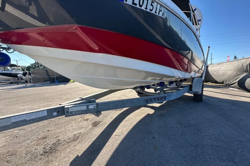 Slide: The Image of 2014 NauticStar 203DC Sport Deck boat on trailer, side view. - 7