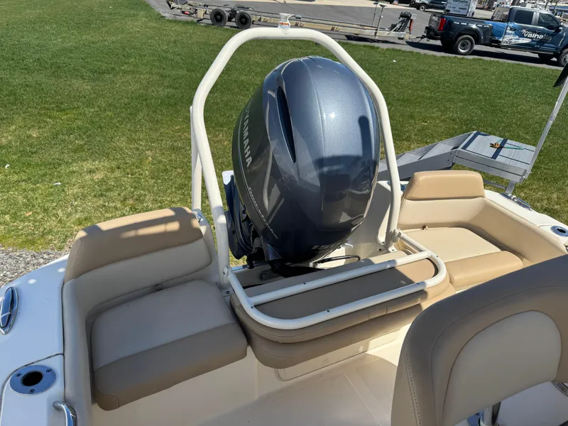 Slide: The Image of 2023 Scout 195 Sportfish boat with outboard motor and beige seating. - 11