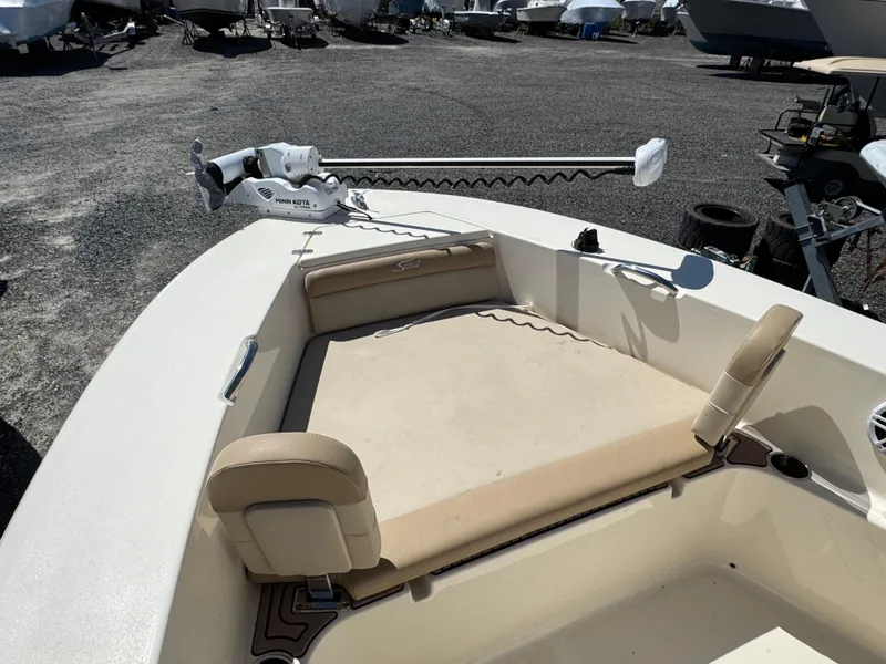 Slide: The Image of 2023 Scout 195 Sportfish boat with beige seating and trolling motor on deck. - 8