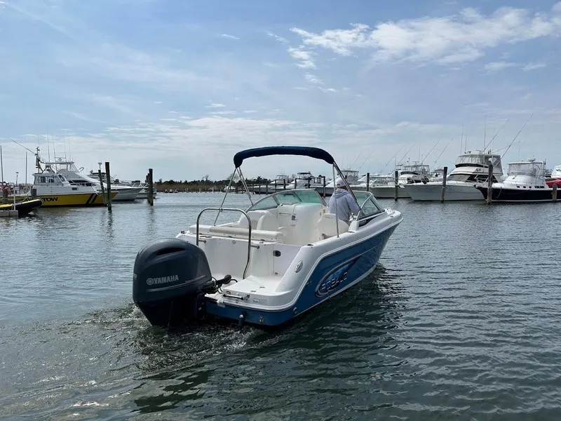 Slide: The Image of 2014 Robalo R227 boat with Yamaha engine on calm water, docked at marina. - 1