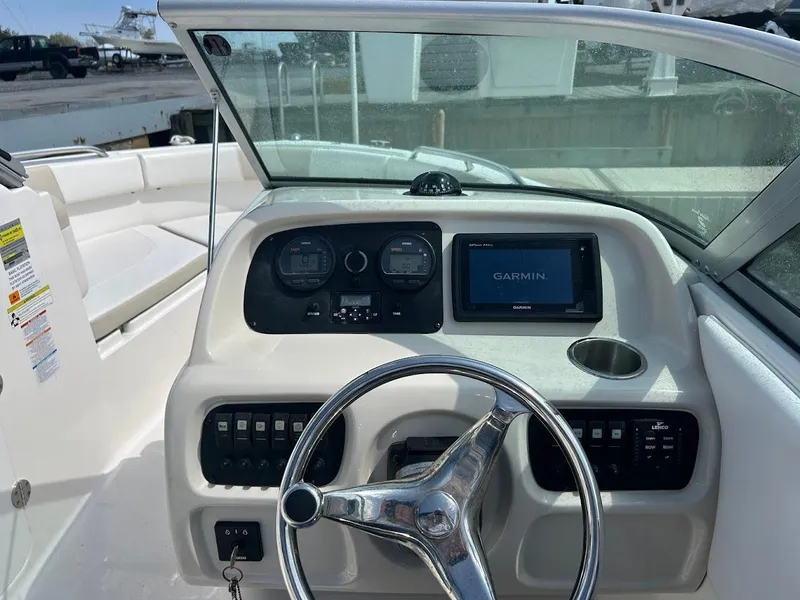 Slide: The Image of 2014 Robalo R227 boat dashboard with Garmin navigation system and steering wheel. - 12