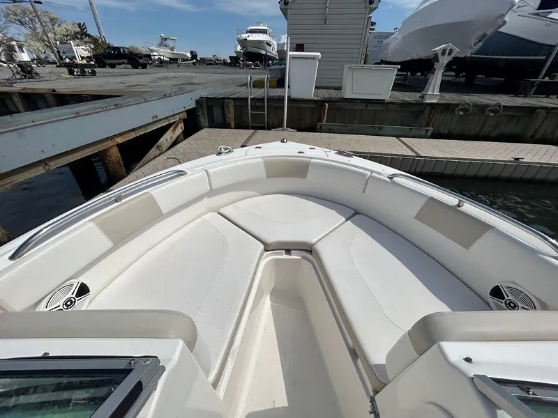 Slide: The Image of 2014 Robalo R227 boat interior at dock, featuring spacious seating and sleek design. - 22