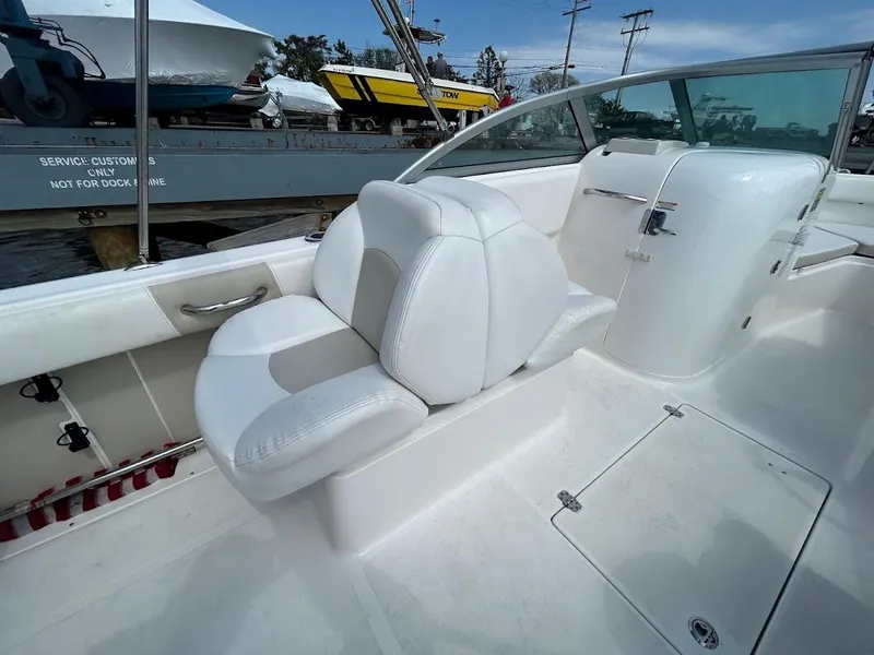 Slide: The Image of 2014 Robalo R227 boat interior with white seating and sleek design. - 25