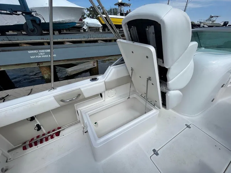 Slide: The Image of 2014 Robalo R227 boat interior with open storage compartment and seating. - 26