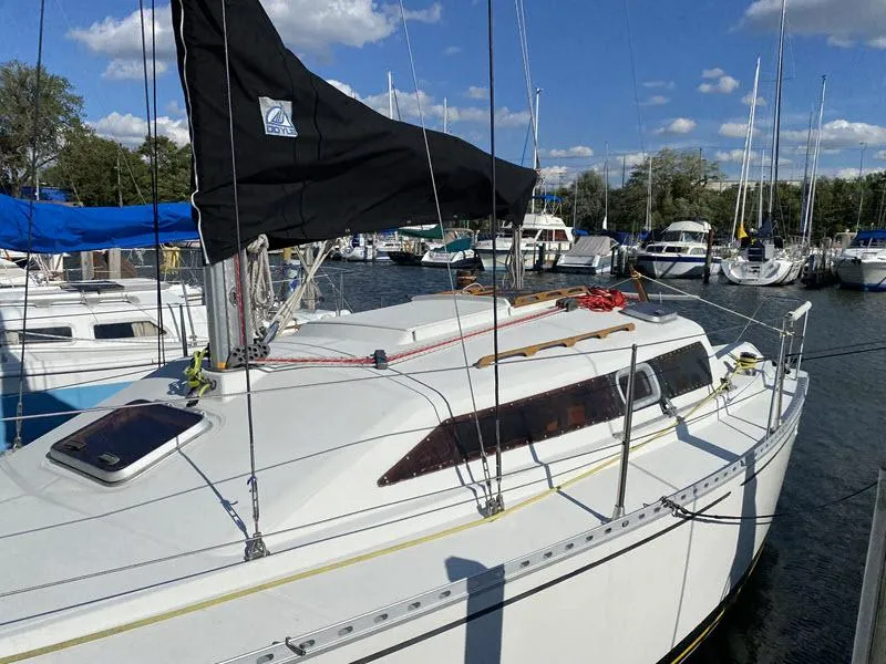 The Image of Sailboat Kirie 286, 1988 model, docked at marina under blue sky. - 0