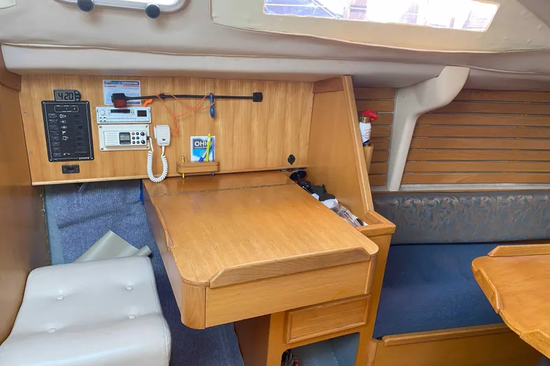 Slide: The Image of Interior of 1988 Kirie 286 sailboat with navigation station and wooden cabinetry. - 12