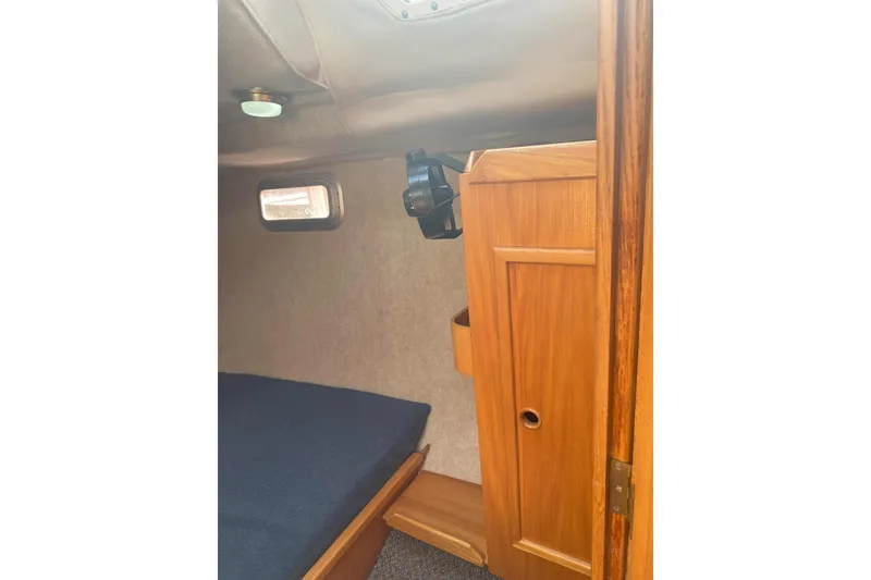 Slide: The Image of Interior cabin of 1988 Kirie 286 sailboat with wooden cabinetry and small window. - 14