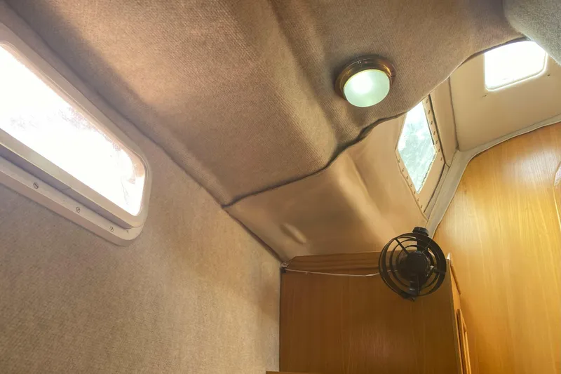 Slide: The Image of Interior of 1988 Kirie 286 sailboat cabin with windows, light, and fan. - 17