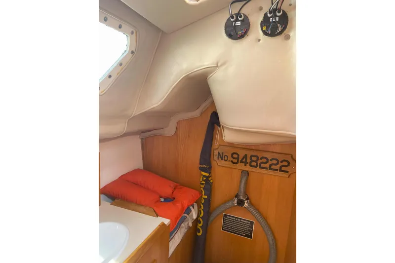 Slide: The Image of Interior cabin of 1988 Kirie 286 sailboat with red bedding and equipment. - 18