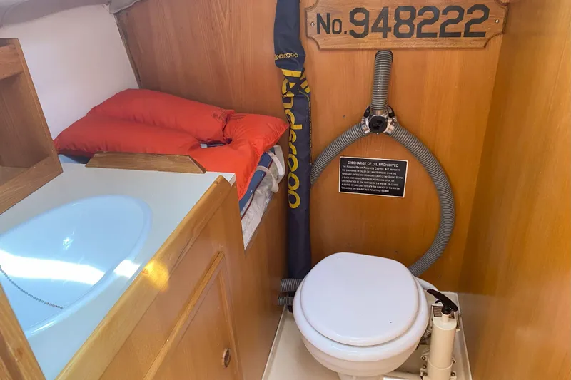 Slide: The Image of Compact boat bathroom with sink, toilet, and storage in a 1988 Kirie 286 model. - 19