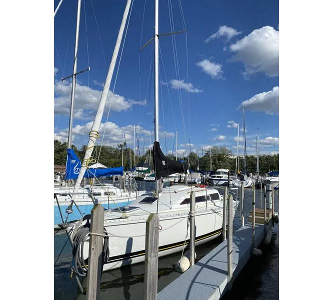 Slide: The Image of Sailboat docked at marina under blue sky, Kirie 286 model, 1988. - 2