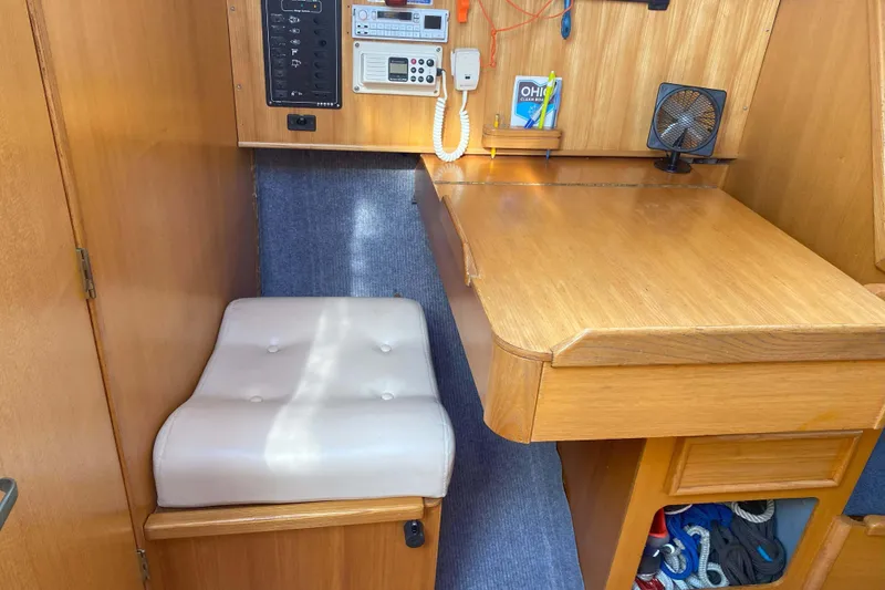 Slide: The Image of Interior of a 1988 Kirie 286 sailboat with navigation station and cushioned seat. - 21