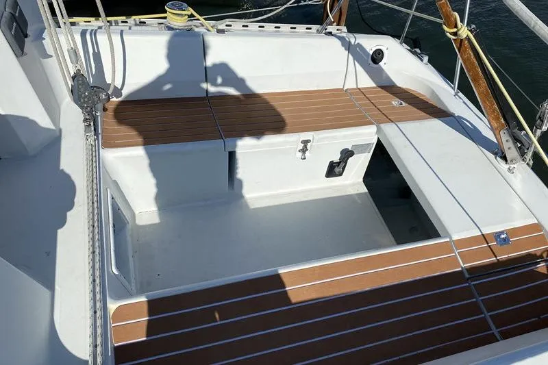 Slide: The Image of Cockpit of 1988 Kirie 286 sailboat with wooden seating and nautical equipment. - 24