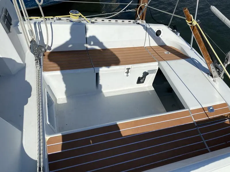 Slide: The Image of 1988 Kirie 286 sailboat cockpit with wooden seating and shadow. - 4