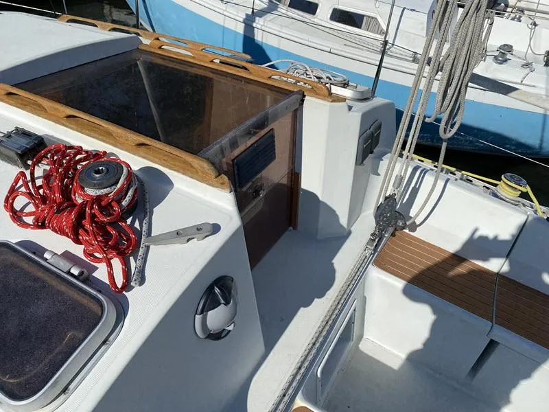 Slide: The Image of Sailboat cockpit of 1988 Kirie 286 with ropes and winch, docked in marina. - 6