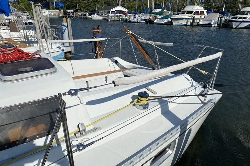 Slide: The Image of 1988 Kirie 286 sailboat docked at a marina, featuring deck and rigging details. - 7