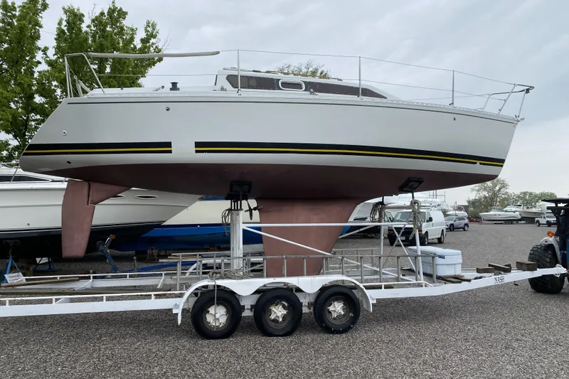 Slide: The Image of Sailboat Kirie 286 from 1988 on a trailer in a boatyard. - 8