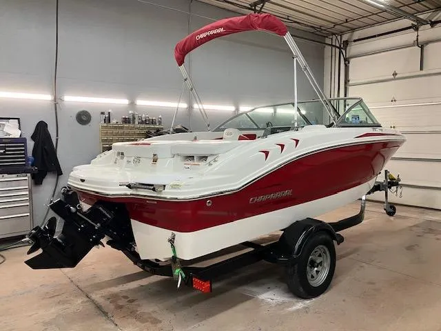 Slide: The Image of 2014 Chaparral 18 Sport H2O boat in garage, red and white design, on trailer. - 1
