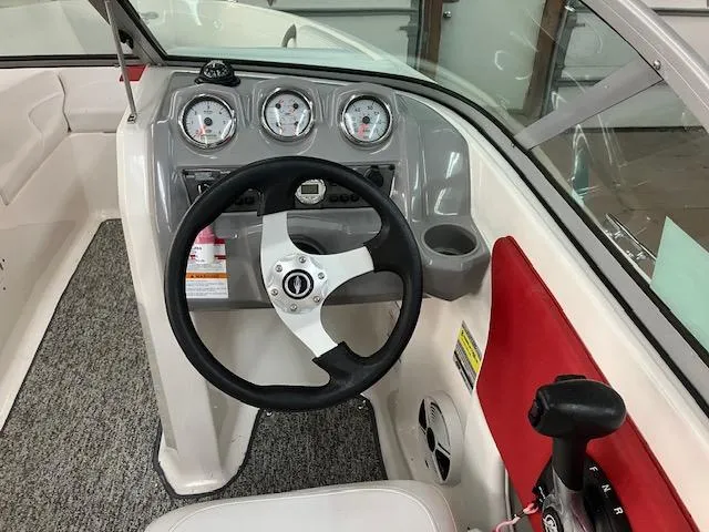 Slide: The Image of 2014 Chaparral 18 Sport H2O boat dashboard with steering wheel and gauges. - 10