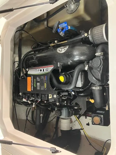 Slide: The Image of 2014 Chaparral 18 Sport H2O engine compartment with detailed view of motor components. - 13