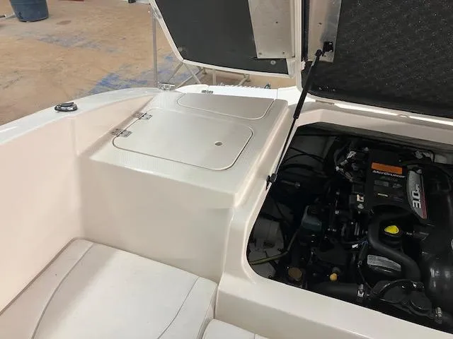 Slide: The Image of 2014 Chaparral 18 Sport H2O boat engine compartment with open hatch. - 14