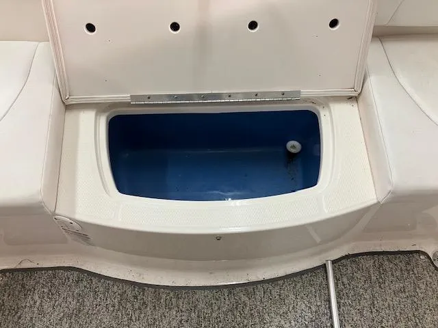 Slide: The Image of Open storage compartment on 2014 Chaparral 18 Sport H2O boat, featuring blue interior. - 15