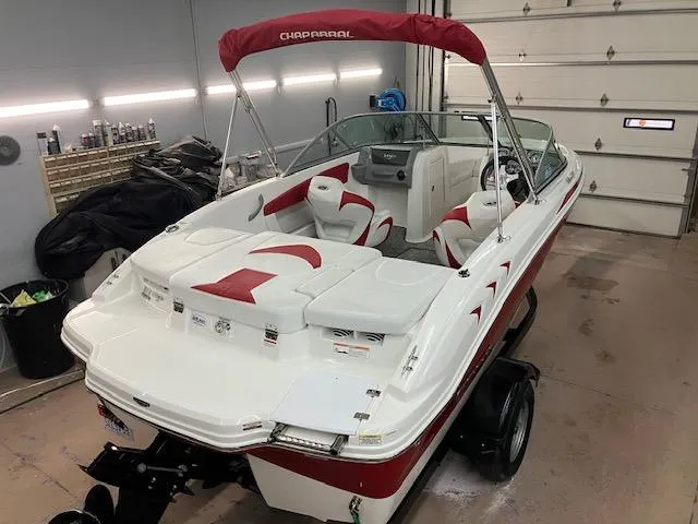 Slide: The Image of 2014 Chaparral 18 Sport H2O boat in garage, red and white interior, on trailer. - 3
