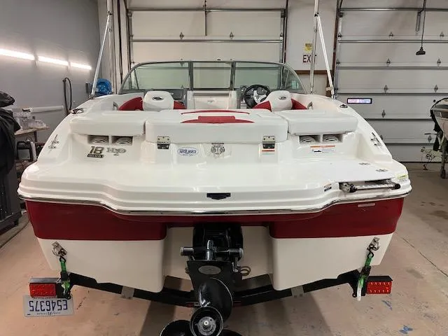 Slide: The Image of 2014 Chaparral 18 Sport H2O boat in garage, rear view, red and white design. - 4