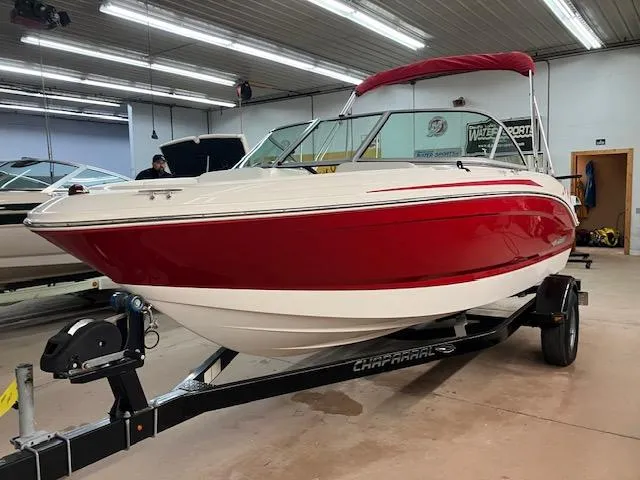 Slide: The Image of 2014 Chaparral 18 Sport H2O boat with red and white design in a showroom. - 8