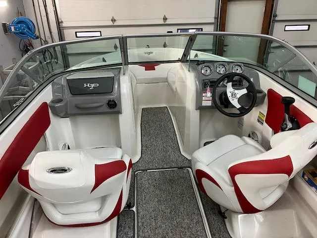 Slide: The Image of 2014 Chaparral 18 Sport H2O boat interior with red and white seating, steering wheel, and dashboard. - 9