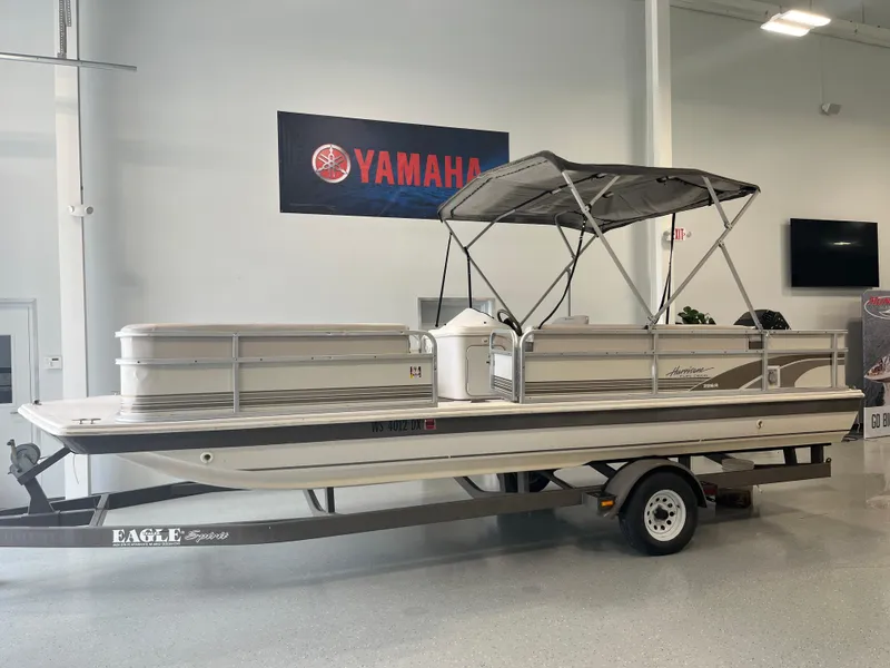 Slide: The Image of 1997 Hurricane 226 RE OB pontoon boat on trailer in showroom. - 1